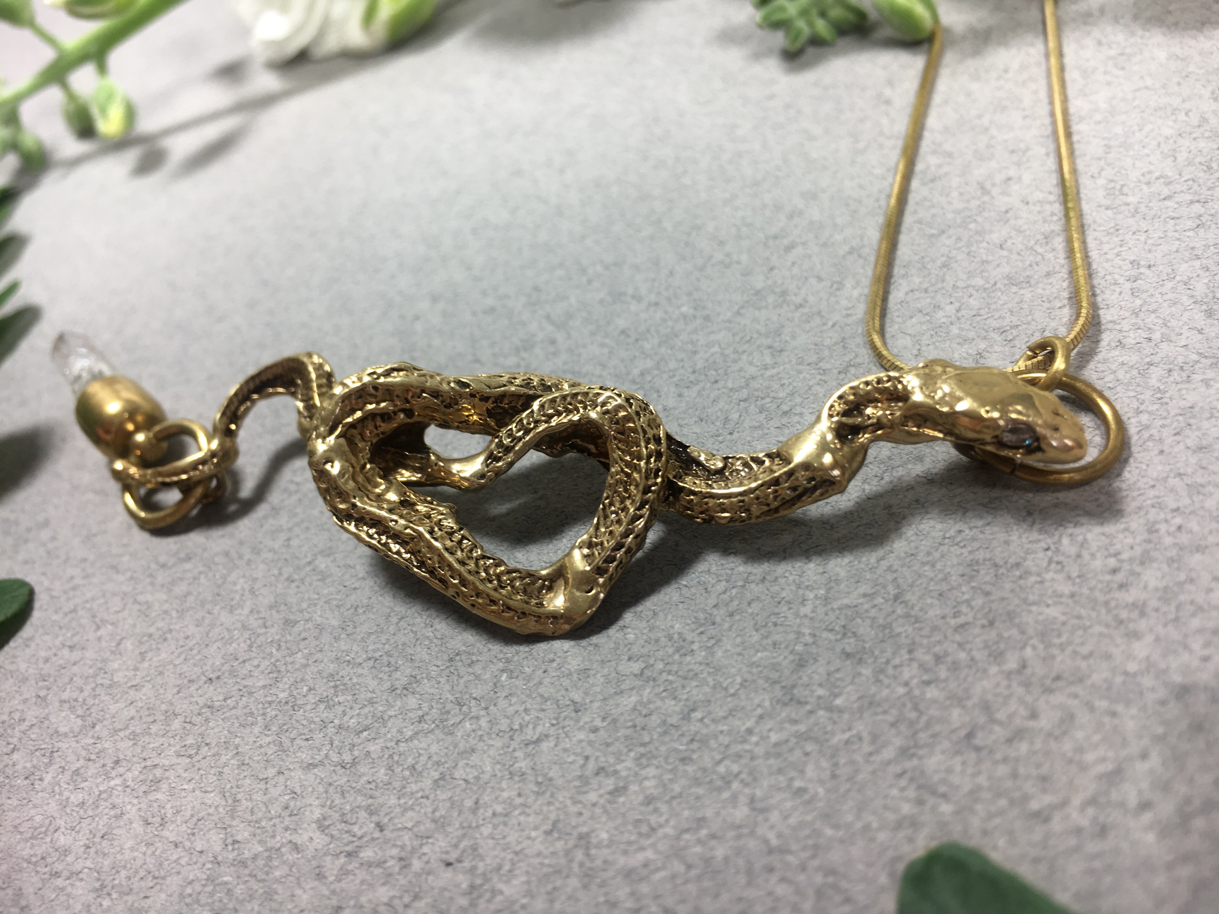Snake pendant with onyx eyes